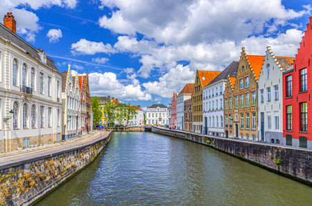 Bruges cityscape, Spiegelrei water canal of Reie river, medieval houses buildings on embankment in Brugge old town quarter district in Bruges city historical center, West Flanders province, Belgiumの写真素材