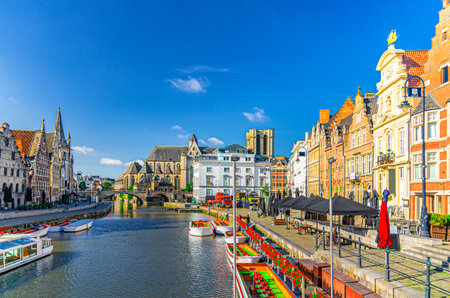 Graslei Grass Quay and Korenlei Corn Wheat Quay on Lys river embankment in Ghent city center with old buildings, Saint Michael's Bridge and Saint Michael's Church, East Flanders province, Belgiumの写真素材