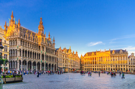 The Grand-Place Grote Markt Big Market square in Brussels city historical center with people, sunset view, King's House Brussels City Museum, House Dukes Brabant and Guilds of Brussels, Belgiumの写真素材