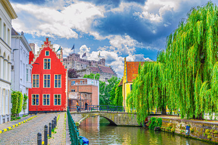Ghent cityscape, embankment promenade of Lieve water canal, old brick buildings, Ghent historical city center Prinsenhof Princes Court, Castle of the Counts in Gent old town, Flemish Region, Belgiumの写真素材