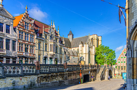 Old traditional houses and Saint Michael's Roman Catholic Church Sint-Michielskerk near Saint Michael's Bridge Sint-Michielsbrug in Ghent city historical center, Flemish Region, Belgiumの写真素材