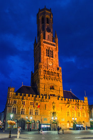 Belfry of Bruges Belfort van Brugge medieval bell tower on Markt Market square in Brugge old town, UNESCO World Heritage site in Bruges city historical centre, evening view, Flemish Region, Belgiumの写真素材