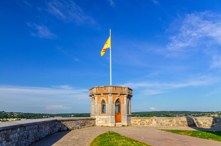 Small tower with Walloon flag on Citadel of Namur Citadelle de Namur stone fortress on hill in historical city centre, skyline horizon background, Wallonia, Walloon Region, Belgiumの写真素材