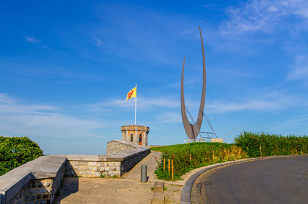 Small tower with Walloon flag on Citadel of Namur Citadelle de Namur stone fortress on hill in historical city centre, blue sky background, Wallonia, Walloon Region, Belgiumの写真素材