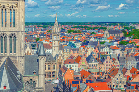 Top view of Ghent city historical center with Saint Nicholas Church Sint-Niklaaskerk, Old Post Office building with clock tower and old colorful buildings in Ghent old town, Flemish region, Belgiumの写真素材
