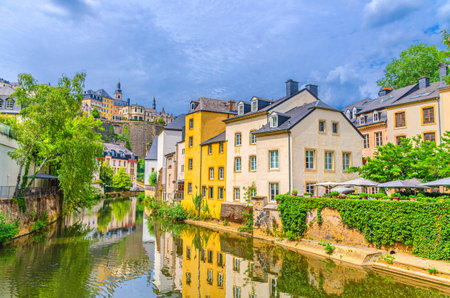 Grund quarter in Luxembourg City historical center with old typical colorful buildings, green trees on bank of Alzette river valley in old town Gronn lower city and Ville Haute quarter backgroundの写真素材