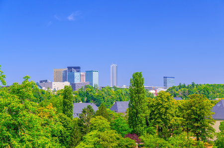 Luxembourg City aerial panoramic view of Kirchberg central business district with skyscraper buildings and Three Acorns Park with green trees, Luxembourg cityscape skyline horizon with blue skyの写真素材