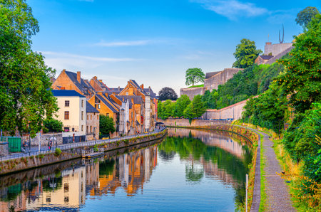 Citadel of Namur Citadelle de Namur stone fortress on hill, Sambre river embankment promenade with old colorful buildings and green trees in Namur historical city centre, Wallonia Region, Belgiumの写真素材