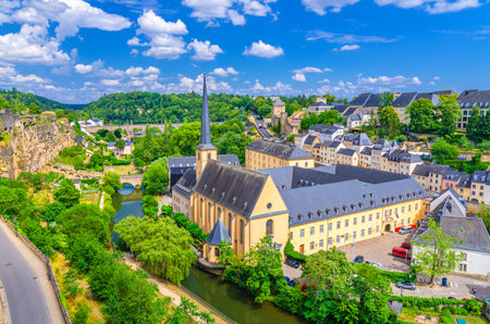 Luxembourg City historical center aerial view with NeimÃ«nster Abbey, Saint John's on the Stone catholic Church, Rham Plateau, Bock Casemates fortification above river Alzette valley in Grund districtの写真素材