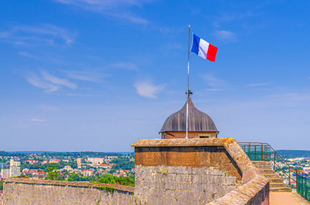 National Flag of France on Guard tower watchtower of stone wall rampart in Citadel of BesanÃ§on Citadelle de BesanÃ§on fortress in old town Besancon city historic center in sunny summer day, Franceの写真素材