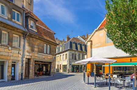 Small square in Besancon old town center ville with old houses, medieval buildings, street restaurants and cafes, La boucle de BesanÃ§on city historic center, Bourgogne-Franche-Comte region, Franceの写真素材