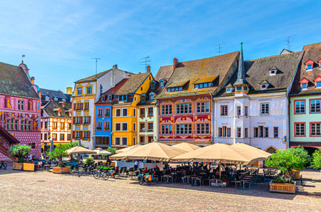 Mulhouse cityscape, typical houses colorful buildings and street restaurant outdoor cafÃ© on Place de la Reunion square in old town Mulhouse city historic centre, Alsace Grand Est region, Franceの写真素材