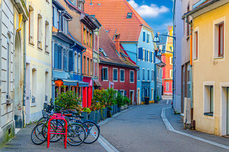 Old town Mulhouse city historic center with narrow pedestrian street, old colorful buildings, typical multicolored houses and parking bikes, Alsace Grand Est region, Franceの写真素材