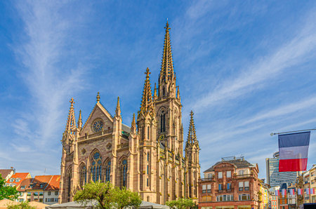 Temple Saint-Etienne Calvinist church Cathedral of Mulhouse building and France flag on Place de la Reunion square in old town Mulhouse city historic centre, Alsace Grand Est region, Franceの写真素材