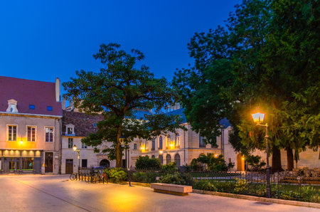 Place des Ducs de Bourgogne square in Dijon city historical center with old typical houses medieval buildings, small park and green square, Dijon old town on twilight dusk evening view, Franceの写真素材