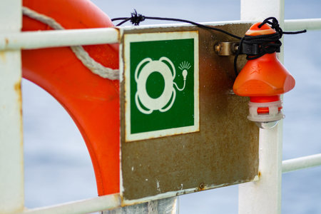Ship emergency station sign with lifebuoy close up detail