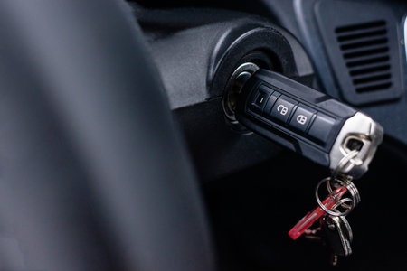 Close up shot of a bunch of keys in the ignition lock of a modern car or van, starting the engine...