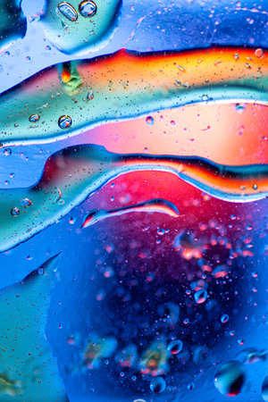 : Colorful abstract wallpaper with a smooth rainbow gradient and delicate oil bubbles reflecting...