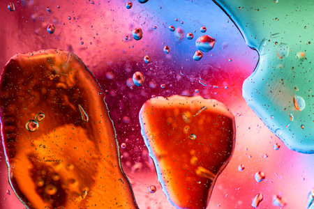 Unique abstract background featuring earthy brown and soft pink liquid tones with floating oil...