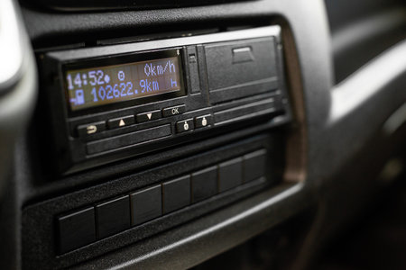 Interior view of a truck dashboard featuring entertainment and regulatory monitoring equipment for...