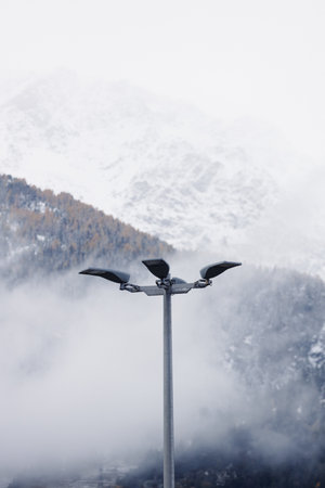 Streetlight against a foggy mountain backdropの写真素材