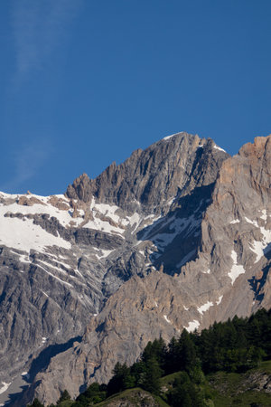 Snow-capped mountain peak under a clear blue skyの写真素材