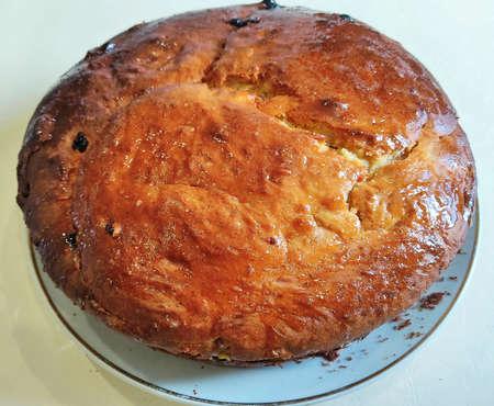 A large round pie, with a golden crust, baked in the oven and laid out on the table. Close-up...