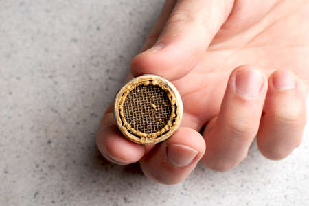 Plumber repairing the faucet of a sink. Plumbing repair concept. Cleaning the aerator on the mixerの写真素材