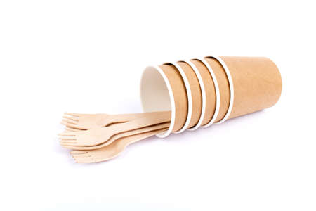 Paper glasses and wooden forks. Eco friendly, compostable tableware, disposable, recyclable on white background. Zero plastic, planet preservation, stop plastic. Recycling concept.の写真素材