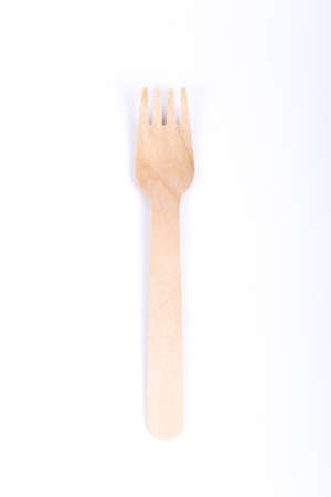 One wooden fork isolated on white background. Eco friendly, compostable tableware, disposable....