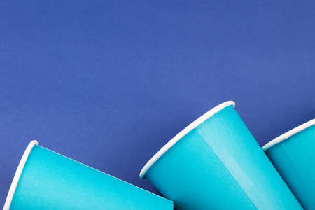 Blue paper glasses isolated on blue backgroud. Eco friendly, compostable tableware, disposable, recyclable on white background. Zero plastic, planet preservation, stop plastic. Recycling conceptの写真素材