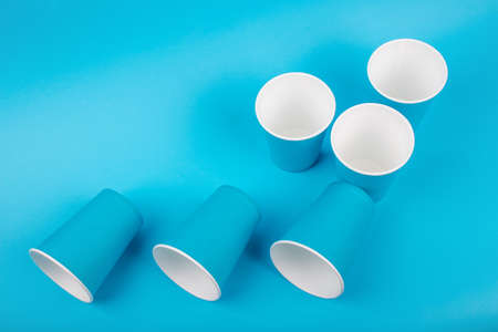 Paper glasses isolated on blue backgroud. Eco friendly, compostable tableware, disposable,...