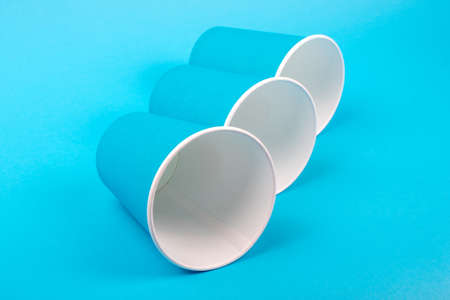 Paper glasses isolated on blue backgroud. Eco friendly, compostable tableware, disposable,...