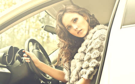 Beautiful young woman in luxury car の写真素材