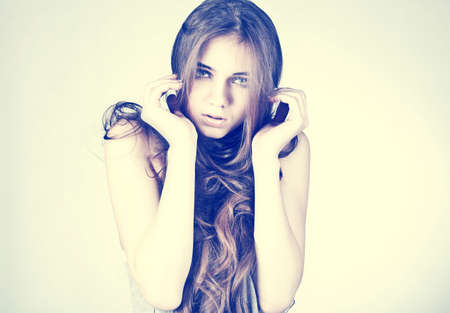 Close-up portrait of a fresh beautiful fashion sexy mod   Portrait of pretty young woman with curly hair の写真素材
