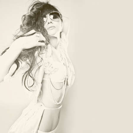 	Fashion portrait of a beautiful young woman wearing sunglassesの写真素材