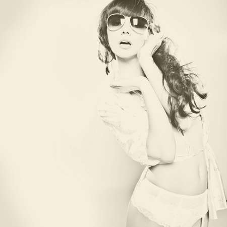 	Fashion portrait of a beautiful young woman wearing sunglassesの写真素材