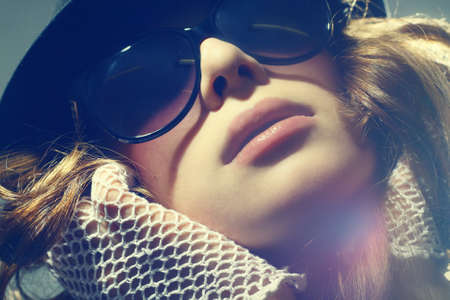 Fashion portrait of a beautiful young sexy woman wearing sunglasses の写真素材