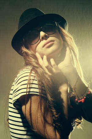 Fashion portrait of a beautiful young sexy woman wearing sunglasses の写真素材