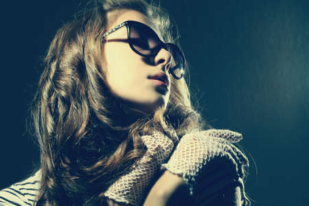 Fashion portrait of a beautiful young sexy woman wearing sunglasses の写真素材