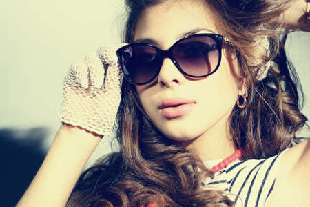Fashion portrait of a beautiful young sexy woman wearing sunglasses の写真素材