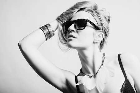 Fashion portrait of a beautiful young woman wearing sunglasses の写真素材