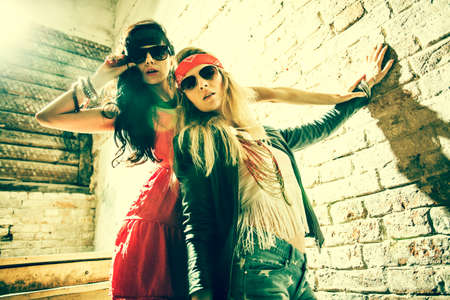 Fashion portrait of a beautiful young womans wearing sunglasses の写真素材