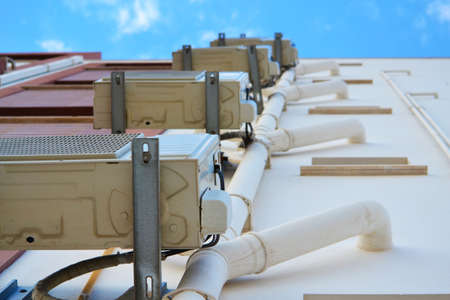Air conditioning systems with tubes on the wall of buildingの写真素材
