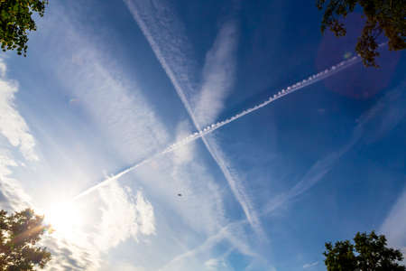Inversion traces from aircraft. Cross in the sky. X-trackの写真素材