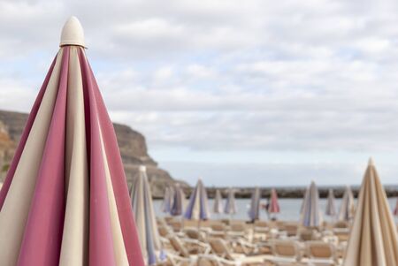 Pink-white Sunshade at the beach of Puerto Mogan, Gran Canaria in January or Winterの写真素材