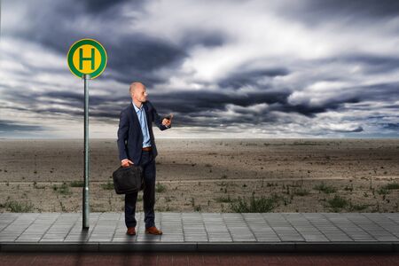 Businessman is waiting at the bus stationの写真素材