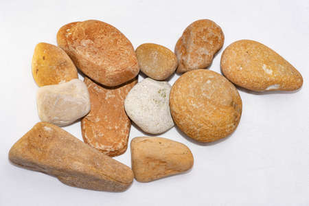 Scattered sea pebbles. Smooth stones isolated on white background