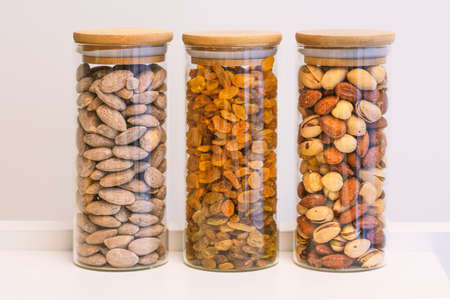 Healthy nuts in the bottle isolated on whiteの写真素材