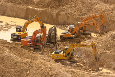 Riyadh, Saudi Arabia, KSA - February 12, 2020 deep digging of new building being constructed in north of Riyadh with engineers and workers and excavator diggerのeditorial素材